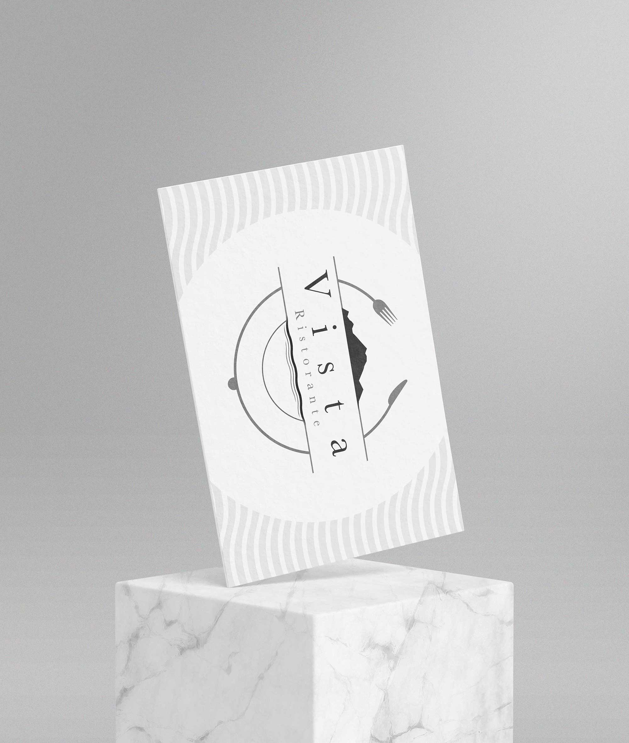 Logo e brand identity di Vista Ristorante a Stresa realizzato da SEBA! grafico di Gravellona Toce nel VCO di un biglietto da visita che poggia su un cubo di marmo bianco